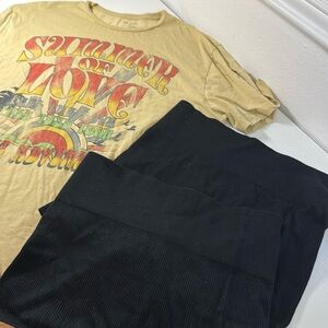 Oversized graphic t with two pair of black fitted shorts.